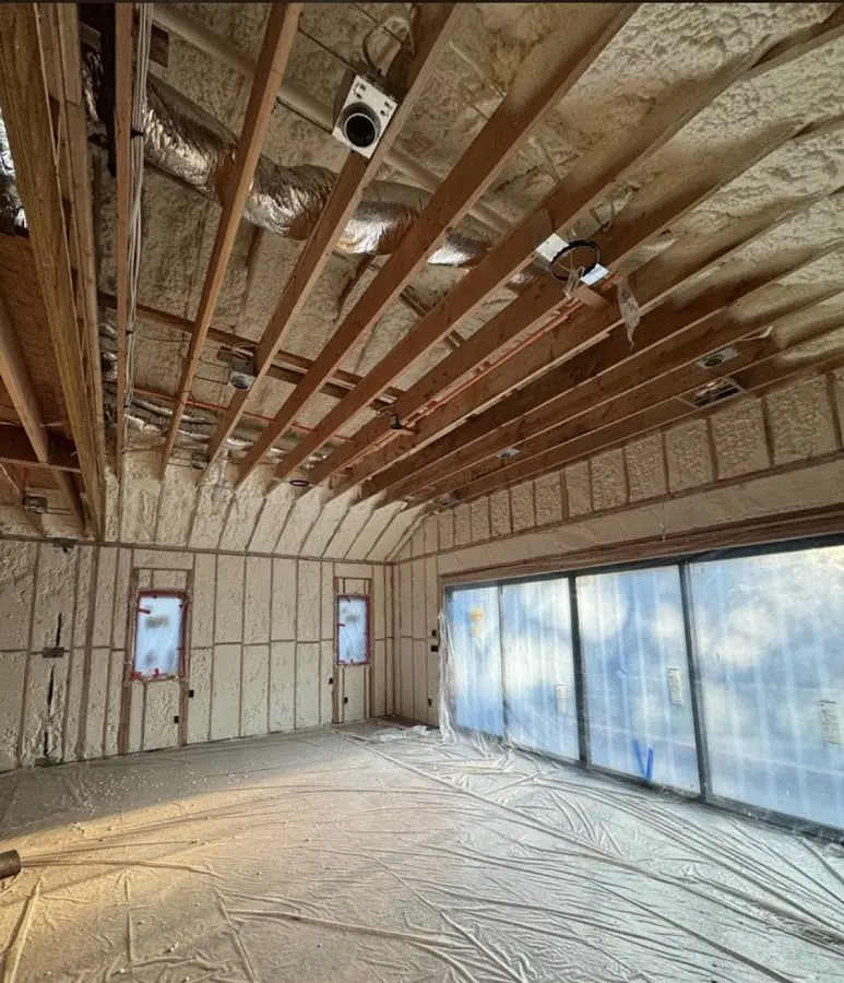 Interior walls and ceiling insulated with spray foam during new construction in Woonsocket